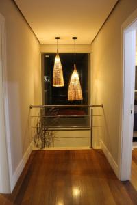 a hallway with two pendant lights in a house at Treetops Home in Teresópolis