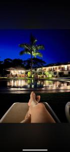 a person laying in a bath tub with their feet up at Tantiri River Resort in Puerto Maldonado