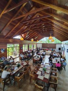 a large dining room with people sitting at tables at Tantiri River Resort in Puerto Maldonado