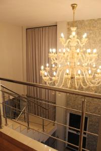 a chandelier in a living room with a fireplace at Treetops Home in Teresópolis +64 photos