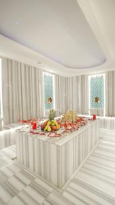 a white room with a table with fruit on it at Trademark By Wyndham Operla Airport Hotels Arnavutköy in Arnavutköy