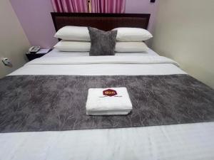 a bed with a blanket and a napkin on it at Excellence Citizens Hotel and Resort in Ilorin +6 photos