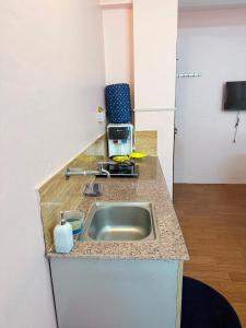 a kitchen counter with a sink and a microwave at Lux Apartment in Kathmandu +11 photos