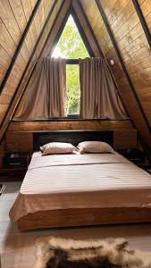 a bed in a room with a large window at AFRAME Solotvino in Solotvyno