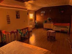 a living room with a bed and a piano at Casa sol e mar in Colares