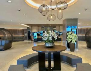 a lobby with a table with flowers on it at Shore 1 Tower D in Manila
