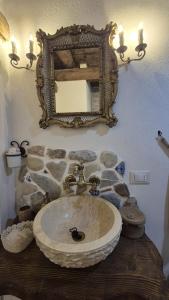 a bathroom with a stone sink and a mirror at La casetta in Trabia