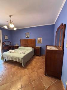 a bedroom with a bed and blue walls at Casa vacanze Selene in Bolsena +55 photos