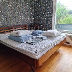 a bed in a room with a large window at Spacious Villa near Gothenburg in Alingsås