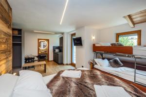 a bedroom with a bunk bed and a living room at B&B Soreghina in Malè