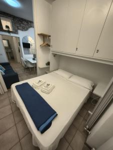 a bedroom with a bed with a blue towel on it at Manarola Sunset House in Manarola