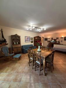 a living room with a wooden table and chairs at Casa vacanze Selene in Bolsena
