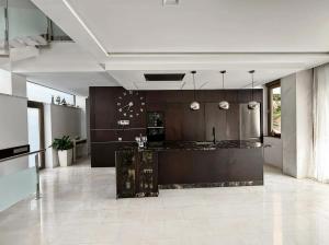 a kitchen with brown cabinets and a counter top at Villa Capitan in Orihuela Costa +73 photos