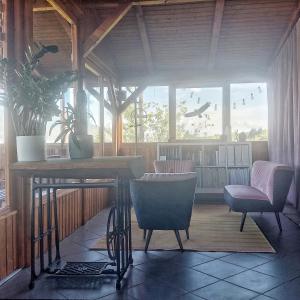 a room with two chairs and a table in a building at Panorama Wine & Chill in Hévíz