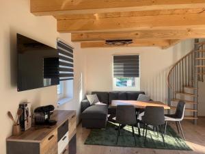 a living room with a table and a couch at Blockhaus Wassermann Spielberg in Spielberg