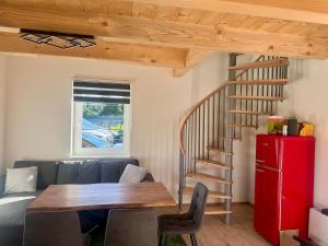 a living room with a wooden table and a staircase at Blockhaus Wassermann Spielberg in Spielberg