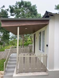 a porch of a house with a wooden roof at The Hillshade villa in Borpāni