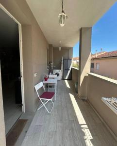 a room with a table and a chair on a balcony at Summer Nest in Cecina