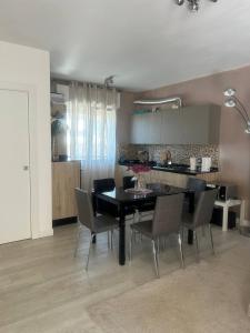 a kitchen and dining room with a table and chairs at Summer Nest in Cecina