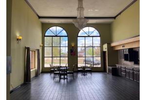 a dining room with tables and chairs and windows at Motel 6 Elkhart, IN in Elkhart