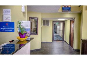 a corridor of a hospital with a reception counter and a hallway at Motel 6 Elkhart, IN in Elkhart