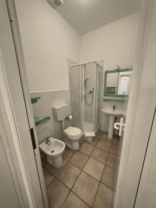 a bathroom with a shower and a toilet and a sink at Manarola Sunset House in Manarola +15 photos