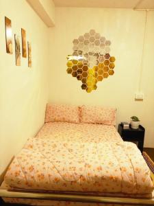 a bedroom with a bed with a sign on the wall at Bravo Hills in Gauhāti +2 photos