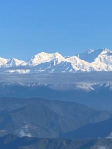a view of snow covered mountains from an airplane at Bravo Hills in Gauhāti