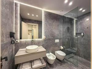 a bathroom with two sinks and a glass shower at Hotel Luxury Palace in Ishull-Lezhë +21 photos