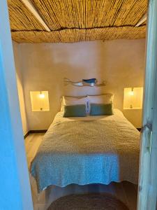 a bedroom with a bed with a wooden ceiling at El Tablado Ocean View House in Güimar