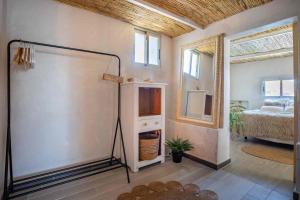 a room with a mirror and a room with a bed at El Tablado Ocean View House in Güimar