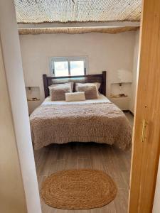 a bedroom with a large bed and a window at El Tablado Ocean View House in Güimar
