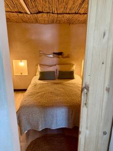 a bedroom with a bed in a room with a ceiling at El Tablado Ocean View House in Güimar +7 photos