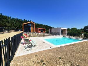 a chair sitting next to a swimming pool at KOARI - Studio Clim, Piscine in Auch