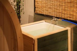 a bath tub with a water fountain at SNUGGLE2222 Hakone Iriuda in Odawara +43 photos