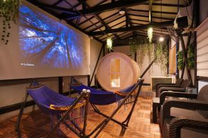 a room with two hammocks and a large screen at SNUGGLE2222 Hakone Iriuda in Odawara