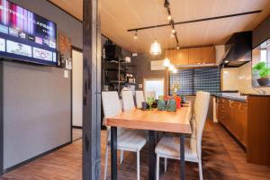 a kitchen and dining room with a wooden table and chairs at SNUGGLE2222 Hakone Iriuda in Odawara