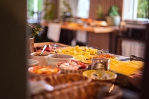 a buffet of food on a table with food at Real NOB Hotel in Orleans