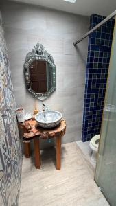 a bathroom with a sink and a mirror at Cozy two-storey home in Ban Lam Praya Phai Rua