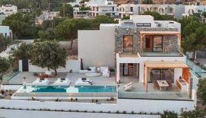 an aerial view of a house with a swimming pool at Aethra Villa - Infinity Pool & Panoramic Sea View in Pefki