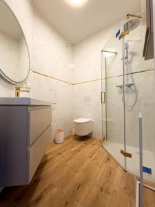 a bathroom with a glass shower and a toilet at Furman's Court in Lublin