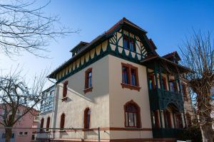 a house with a gambrel roof on top of it at Villa Weißbach - Haus Hilda in Flöha