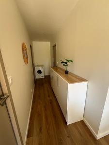 a room with a white cabinet with a plant on it at Logement en campagne in Bédarrides