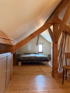 a bedroom with a bed in a attic at Cozy Cottage - Authentic apartment in Mullerthal in Waldbillig