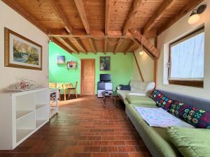 a living room with a couch and a table at Cozy Cottage - Authentic apartment in Mullerthal in Waldbillig