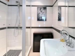 a bathroom with a white sink and a fireplace at Cozy Cottage - Authentic apartment in Mullerthal in Waldbillig +15 photos