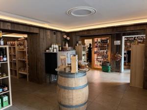 a store with a barrel in the middle of a room at Cozy Cottage - Authentic apartment in Mullerthal in Waldbillig