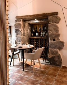 a dining room with a table and a wine cellar at Casa As Fontes in Porqueirós