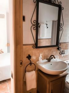 a bathroom with a sink and a mirror at Casa As Fontes in Porqueirós +51 photos
