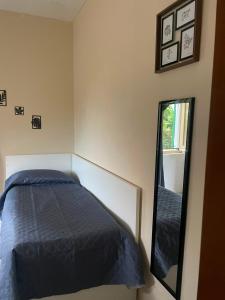 a bedroom with a bed and a mirror at Little fox in Miglianico